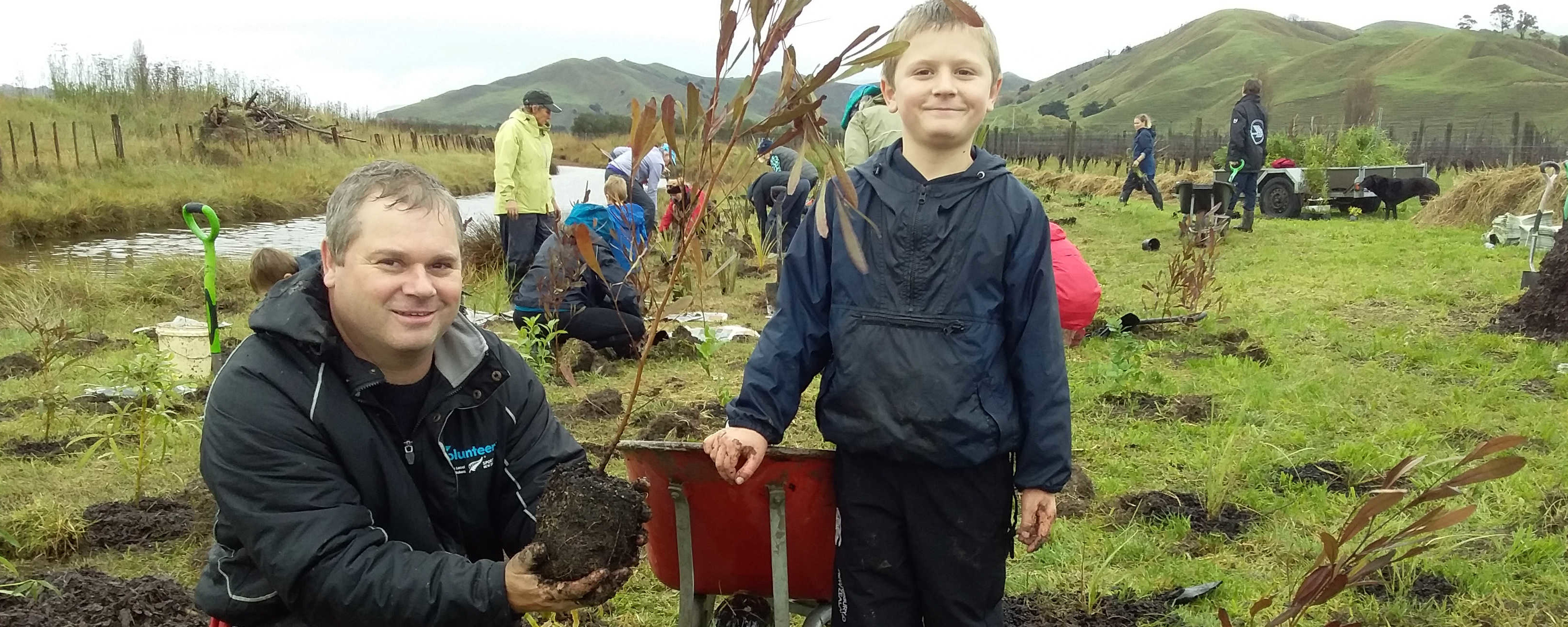 Geoff and Luke planting native tree at our salt marsh reserve